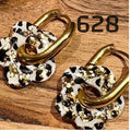 Quaste, Leopard und Gold